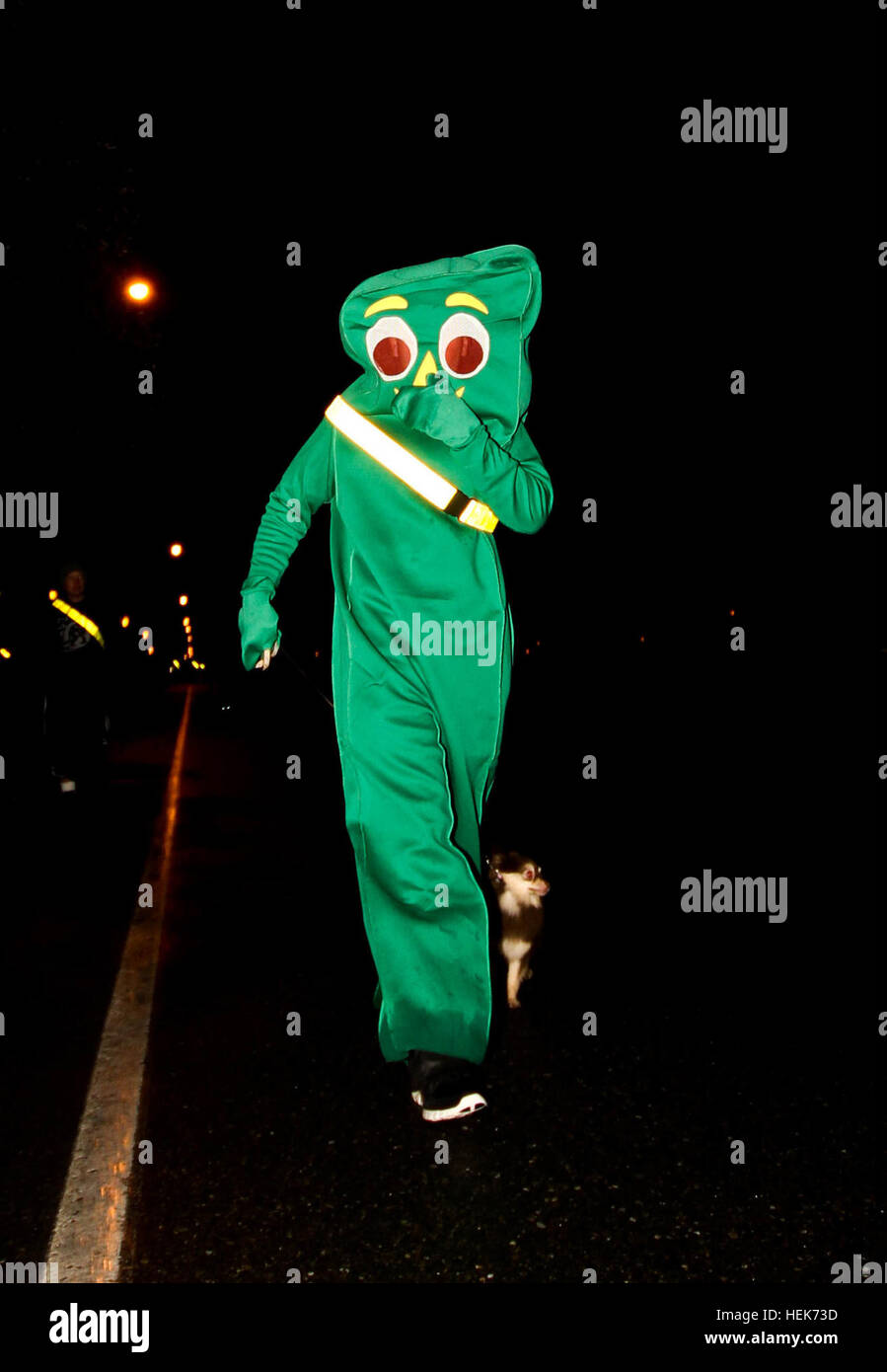'Gumby' and his dog run for fun during the 593rd Special Troops Battalion Halloween 'costume run' Oct. 29. Gladiator's costume run raises spirits for Halloween 334899 Stock Photo