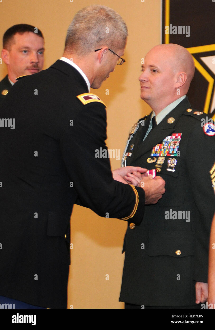 Col. Ronald Place, the Fort Knox Medical Department Activity commander, pins the Meritorious Service Medal on Sgt. 1st Class Charles Hibbs, a paralegal noncommissioned officer with the 3rd Sustainment Command (Expeditionary), during his retirement ceremony Nov. 23 at the Fort Knox Leader's Club. Hibbs hopes to continue serving soldiers as a civilian while pursuing a bachelor's degree in psychology or sociology. (U.S. Army photo by Staff Sgt. Rob Strain) Moving on, Sustainers retire from the Army after more than 20 years of service 344531 Stock Photo