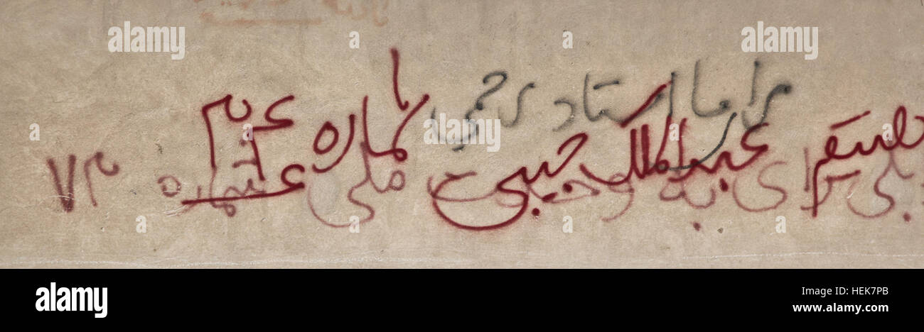 Graffiti on a wall, in red writing, reads, Abdul Malik Habibi number 34 ...