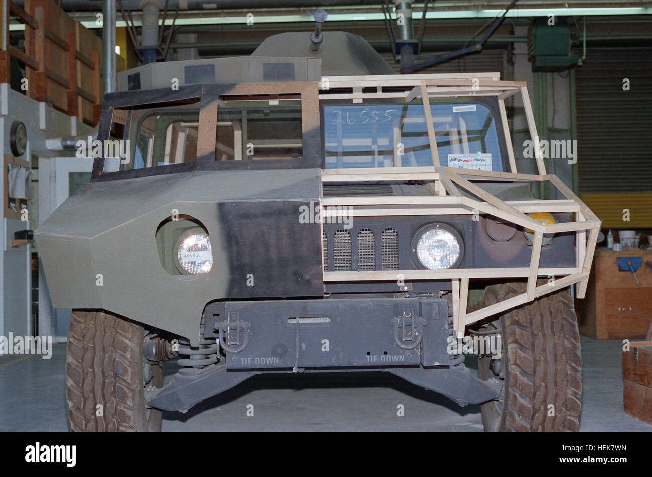 A front view of an M988 High-Mobility Multipurpose Wheeled Vehicle (HMMWV)  with the half-finished shell of a Soviet vehicle being built around it. The  vehicle will be used by the 177th Armored