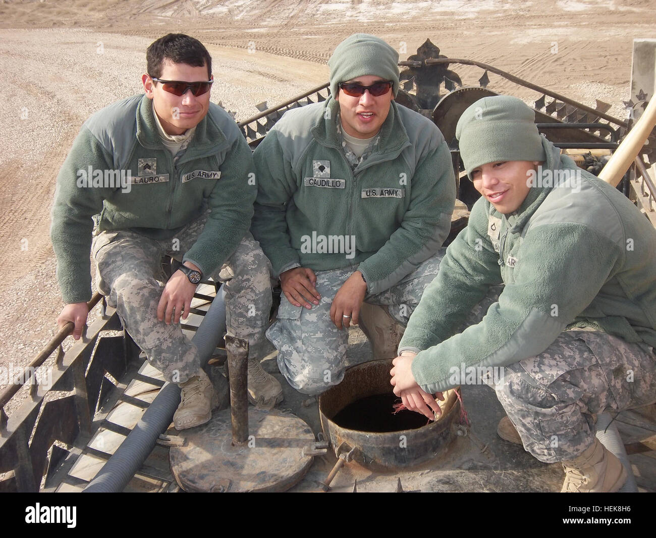 From left, U.S. Army Sgt. Jordan Lauro, Brooking, Ore., Spc. Juan Caudillo, El Paso, Texas, and Pfc. Bryan Aleman, Dallas, all water treatment specialists with Company A, 404th Aviation Support Battalion, 4th Combat Aviation Brigade, 4th Infantry Division, ISAF purify and distribute potable water to military and civilian personnel who reside on Camp Marmal. (Photo by: U.S. Army) 4th CAB Water Dogs dig for water in the desert 361039 Stock Photo