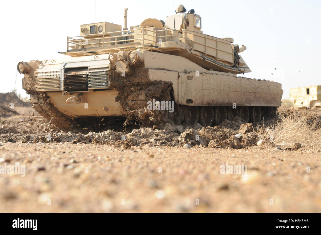 An Iraqi Army tanker with the 9th Armored Division drives an M1A1 Abrams tank under the instruction of soldiers with Company C, 1st Battalion, 18th Infantry Regiment, 2nd Advise and Assist Brigade, 1st Infantry Division, United States Division-Center Jan. 16 at Camp Taji, Iraq. The IA tankers are preparing for a 45-day new equipment operator's course this spring at the Besmaya Combat Training Center, Iraq. Iraqi Army drives into future with M1A1 Abrams tanks 361427 Stock Photo