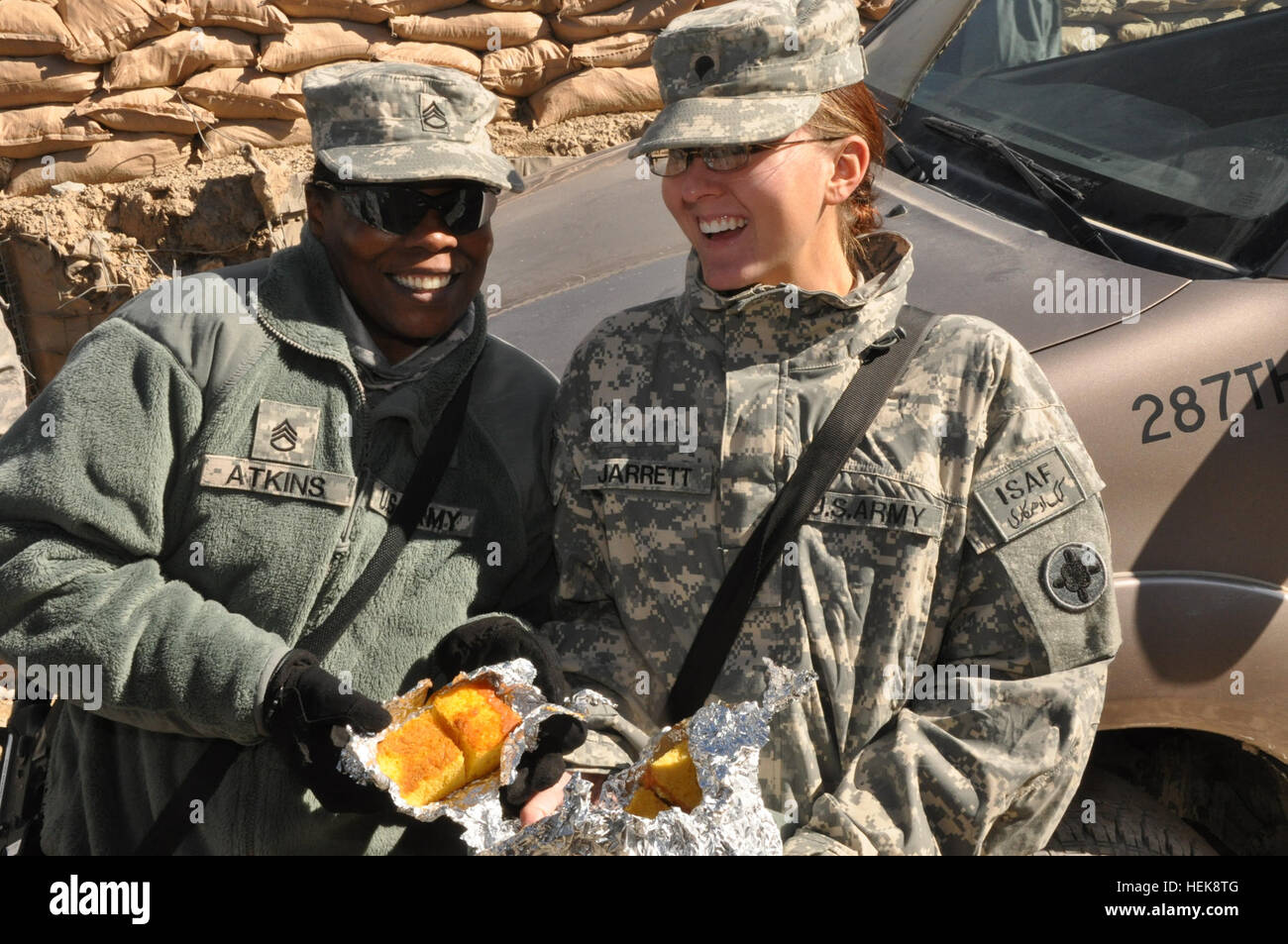(Left) U.S. Army Staff Sgt. Stephanie B. Atkins and Spc. Stephanie E. Jarrett display freshly baked cornbread during a recent battlefield circulation visit to the 287th Engineer Company stationed at Forward Operating Base Lightning, Paktya province, Afghanistan, on Jan. 26, 2011. Both are members of Joint Sustainment Command - Afghanistan, a Mississippi Army National Guard unit, assigned to Kandahar Airfield, Afghanistan. The 287th is a Mississippi Army National Guard based out of Lucedale, Miss., and has deployed since May in search of roadside bombs in southeastern Afghanistan. Mississippi A Stock Photo