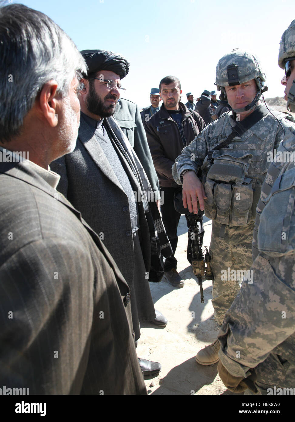 U.S. Army Col. Sean Jenkins, Task Force Currahee, 4th Brigade Combat Team, 101st Airborne Division Commander speaks with National Director of Security for Paktika Col. Satar Khan and Paktika Gov. Moheebulah Samim during a meeting held at the Afghan Uniformed Police Officers Compound located near Forward Operating Base Kushamond, Paktika province, Afghanistan Jan. 27, 2011. The meeting was held to discuss the loss of twenty innocent civilians killed earlier in the week by an improvised explosive device. Key Leader engagement with Paktika Gov. Moheebullah Samim. 364073 Stock Photo