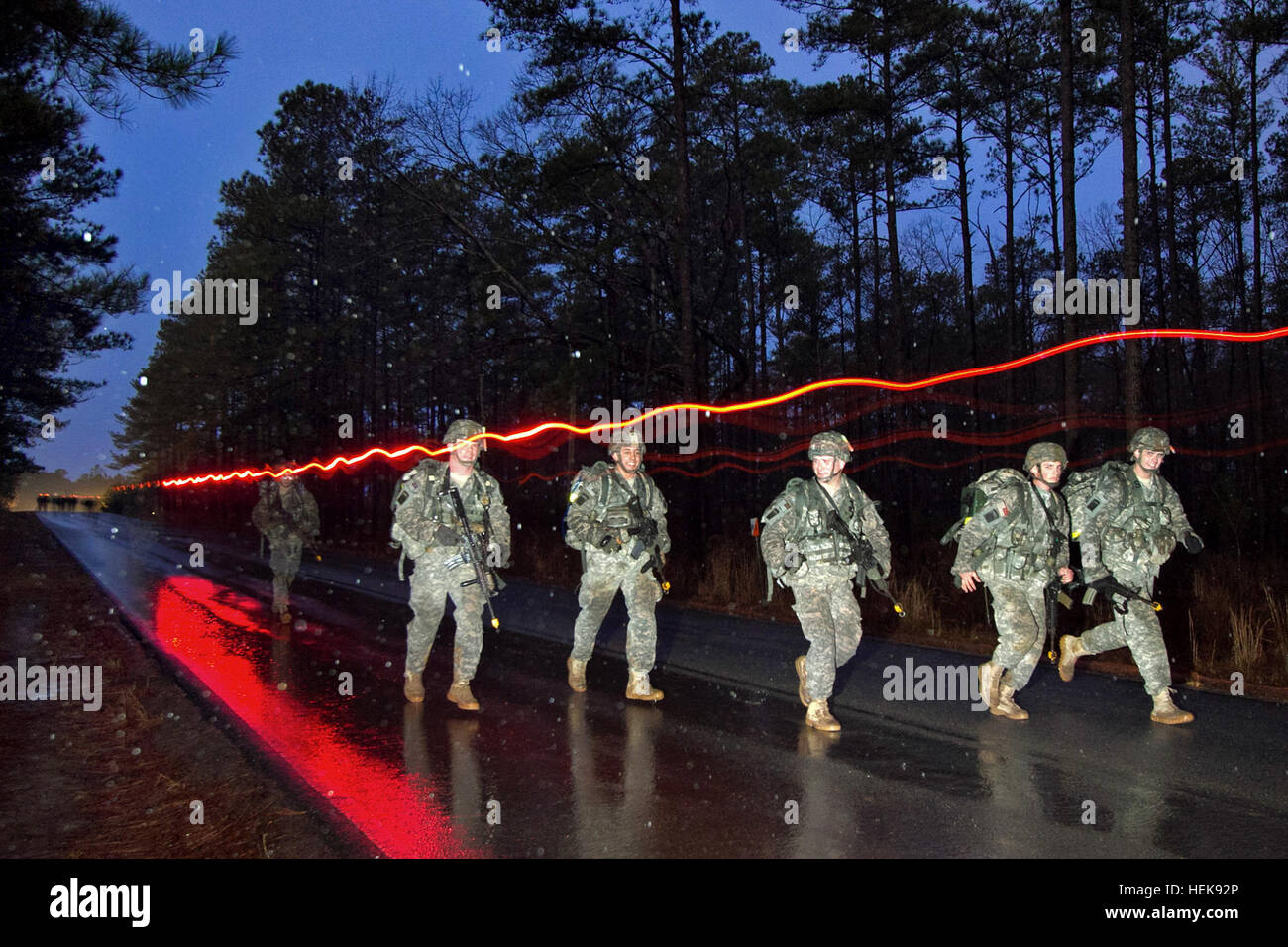 Paratroopers with the 82nd Airborne Division’s 1st Brigade Combat Team move through heavy rain during a 12-mile ruck march, the final event of a week of testing to win the Expert Infantry Badge, Feb. 4, 2011.  All 65 candidates who began the march finished in the allotted three hours.  (U.S. Army photo by Sgt. Michael J. MacLeod) Flickr - The U.S. Army - Earning the badge Stock Photo