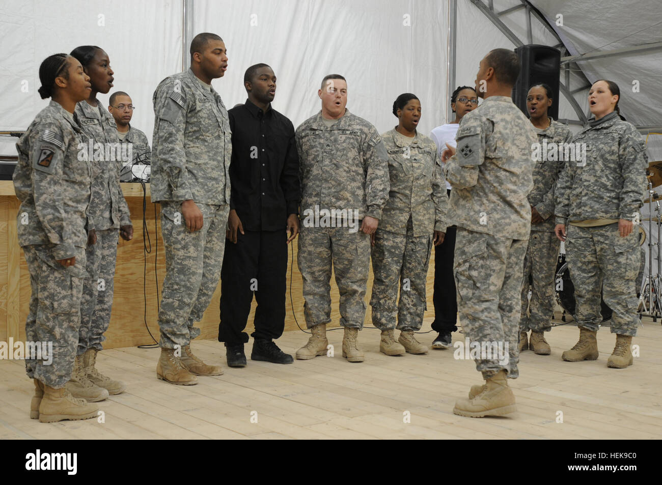 The 4th Combat Aviation Brigade gospel choir, led by Staff Sgt. Brian Rosette, the store section non-commissioned officer in charge of Company A, 404th Aviation Support Battalion, 4th Combat Aviation Brigade, 4th Infantry Division, from Houston, Texas, sing traditional gospel songs during a Black History Month celebration, Feb. 25, at Camp Marmal. The ceremony was a celebration intended to inspire and educate service members about the history and achievements of black Americans. (U.S. Army photograph by Sgt. Sean Harriman) 4th Combat Aviation Brigade celebrates Black History Month 110225-A--00 Stock Photo