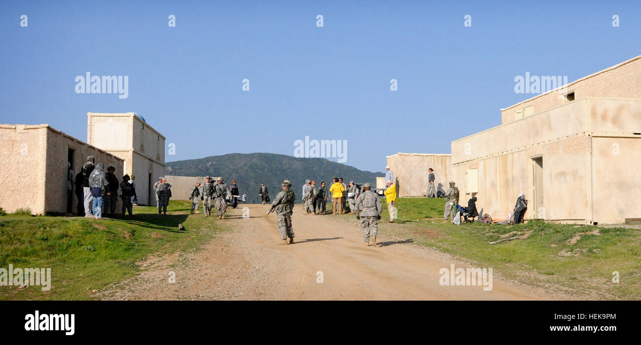 Soldiers patrol and talk with villagers during a mock SWEAT MSO