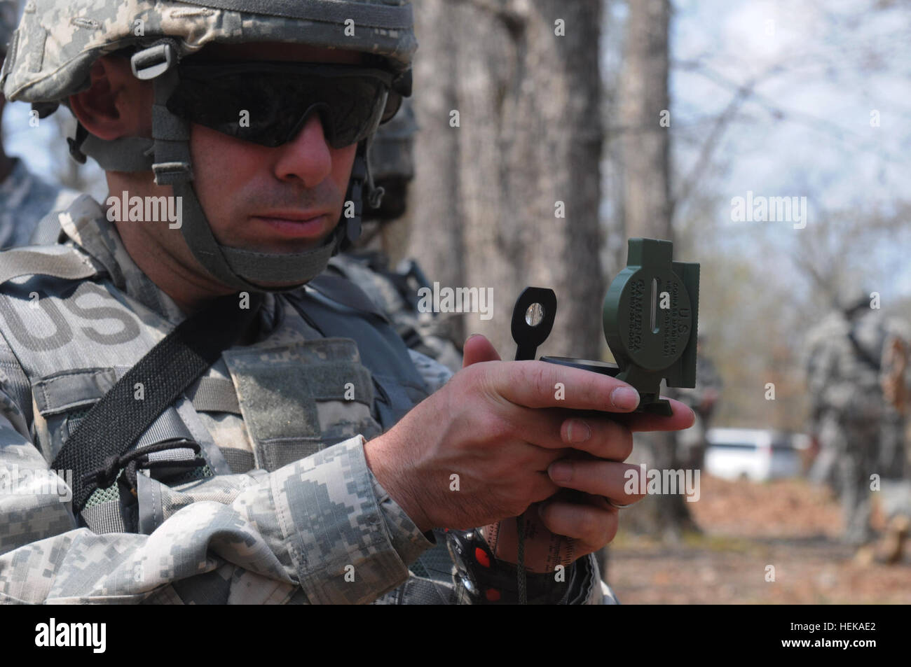 Soldier Using Compass A U.S. Army soldier practices land navigation using a compass during ...