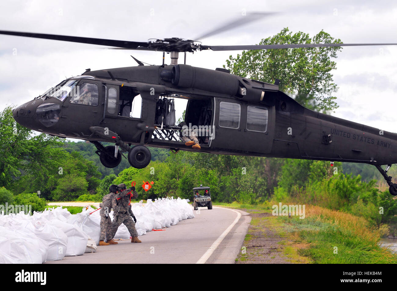 The Missouri National Guard asssited Atchison County authorities with personnel and a UH-60 Blackhawk Helicopter to repair levee L550 near Phelps City as the fight against the flood continues.  The Blackhawk was used to move over 145 Sandbags weighing two thousand pounds each onto areas of the levee damaged by overtopping in recent days.  The levee is being repaired with the expectation that it will prevent a full breach which would cause more severe flooding and would close state highway 136 located nearby. In this photo, Sgt. Arron Keesler, crew chief, C Co, 1/106th Avn Rgmt and Spc. Shane A Stock Photo