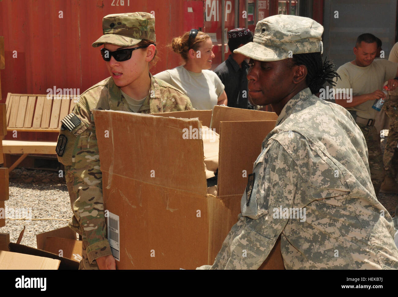 U.S. Army service members carry boxes of donated school supplies to be distributed to local Afghan children attending the Kandahar Airfield Bazaar School June 25. The school supplies were provided through a unique collaboration between Mid-Gulf Forestry Inc. and students from Parklane Academy in McComb, Miss. Mississippi Army National Guard soldiers donate backpacks and school supplies to Afghan children 424532 Stock Photo