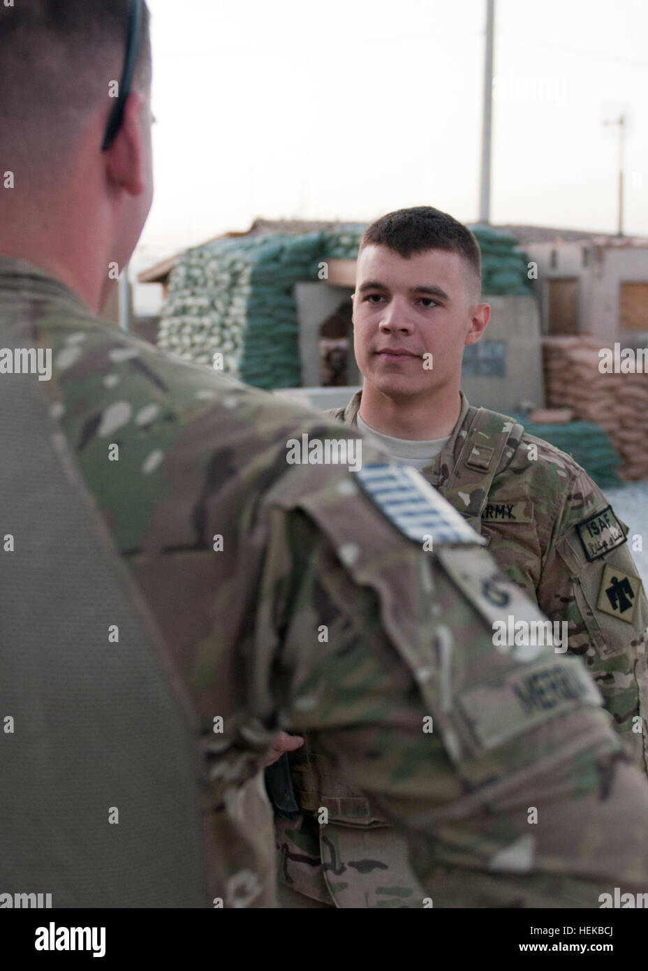 Spc. Josh J. Arias from Canton, Okla., of Company B, 1st battalion, 179th Infantry Regiment, 45th Infantry Brigade Combat Team, talks to fellow battle buddy before heading out on a mission July 2. The 45th IBCT has taken command over several provinces in Afghanistan. Oklahoma Guardsman experiences first deployment to Afghanistan 477231 Stock Photo