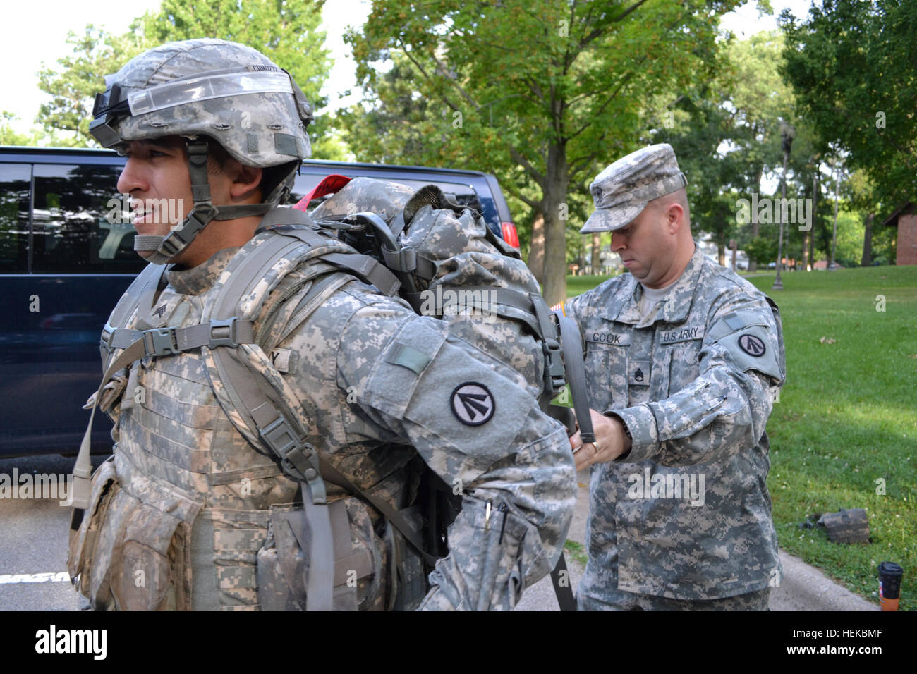 At the start of Day 4 of the week-long 2011 Army Materiel Command Best Warrior competition July 14, 2011, at Rock Island Arsenal, Ill., Staff Sgt. Christopher Cook (right) assits Sgt. Douglas McBroom prepare for the day land navigation course.  McBroom, Military Surface Deployment and Distribution Command's 2011 NCO of the Year, captured the top spot in the AMC NCO of the Year competition, as well. Cook and McBroom are assigned to SDDC's 597th Transportation Brigade at Joint Base Langley-Eustis, Va. AMC Best Warrior competition 110714-A-IU332-002 Stock Photo