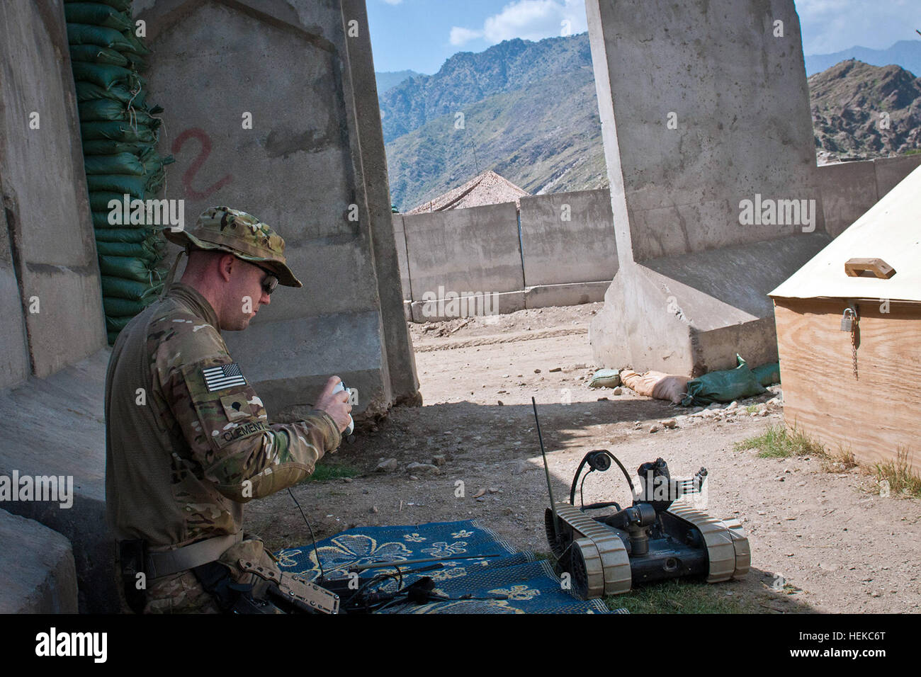 KUNAR PROVINCE, Afghanistan – Explosive ordnance disposal technician, U.S. Army Spc. Andrew B. Clement, a native of Jackson, Tenn., assigned to 129th EOD out of Fort Lewis, Wash., attached to 3rd Brigade Combat Team, 25th Infantry Division, Task Force Bronco, gets a refresher course on a Pacbot 310 EOD robot at Combat Outpost Honaker-Miracle in eastern Afghanistan's Kunar Province, Aug. 1. Clement said the robot is compact enough to be carried in a backpack for dismounted patrols. (Photo by U.S. Army Sgt. 1st Class Mark Burrell, 210th MPAD) Electronics keep soldiers safe distance from IEDs 110 Stock Photo
