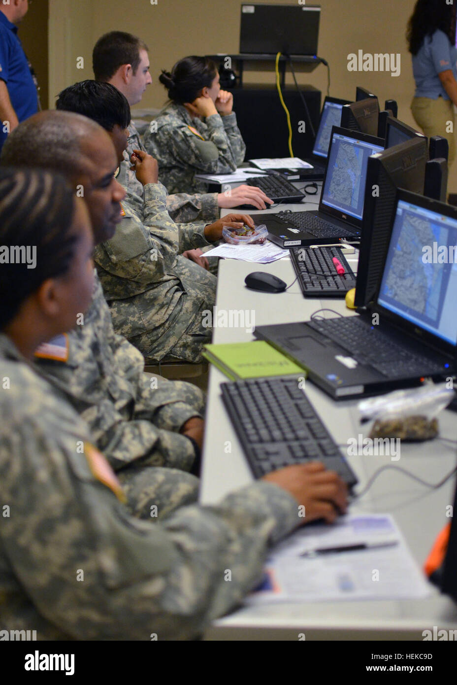 Army 1st Lt. Shannon Bass, Sgt. Daniel Mebane, Spc. Gabrielle Sumner, Spc. Jason Gefre, and Sgt. Merissa Alcala work on two- and three-dimensional map skills during Command Post of the Future training held at Fort Leavenworth, Kan. The training, held, Aug. 4-16, is intended to prepare the soldiers of HHD, 372nd Military Police Battalion for its upcoming deployment to Guantanamo Bay, Cuba. (U.S. Army Photo by Spc. Tyrone Williams) District of Columbia National Guard trains at Fort Leavenworth 647088 Stock Photo