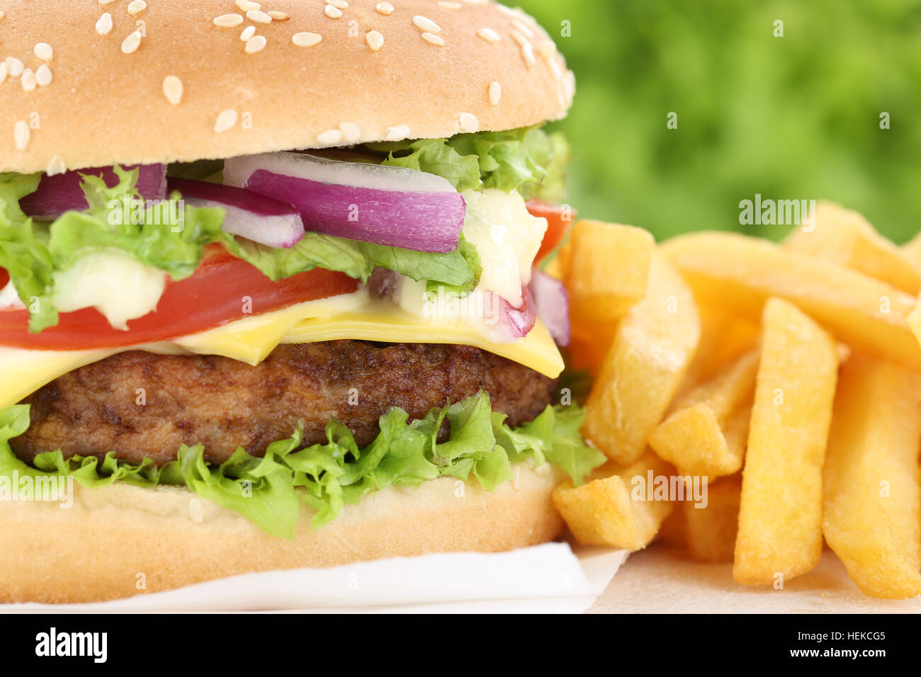 Cheeseburger hamburger with fries closeup close up beef tomatoes