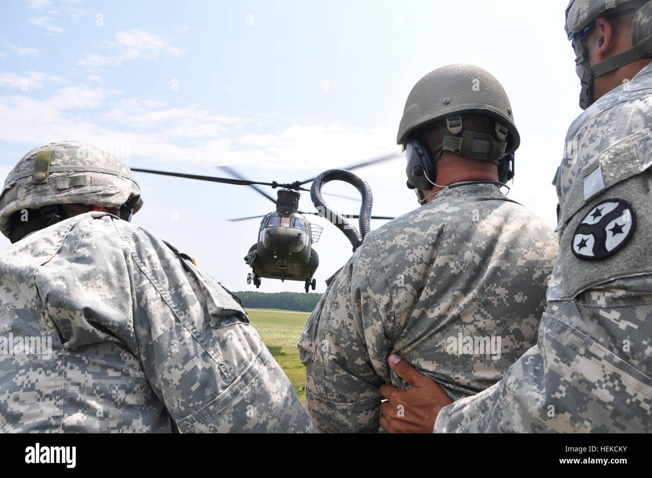 Soldiers from the Fort Benning-based Warrior Training Center teach students sling load operations a CH-47 Chinook helicopter during U.S. Army Pathfinder School at Fort Pickett, Va., Aug. 19. The mission of a Pathfinder is to provide technical assistance and advise the ground unit commander on combat assault operations, sling load operations, air movement, airborne operations, and aerial re-supply by fixed and rotary wing aircraft. Pathfinder course comes to Virginia 110819-A--299 Stock Photo