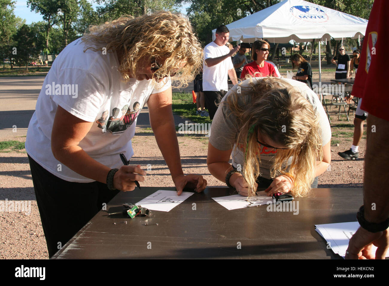 Jamie Johnson, left, and her daughter, Erica Johnson, fill out bibs before the start of the Run for the Fallen. Both women ran on behalf of Master Sgt. Charles L. Price III, Headquarters and Headquarters Company, 2nd Brigade Combat Team, 4th Infantry Division. Price died Aug. 12 in Afghanistan. Community remembers fallen 448417 Stock Photo