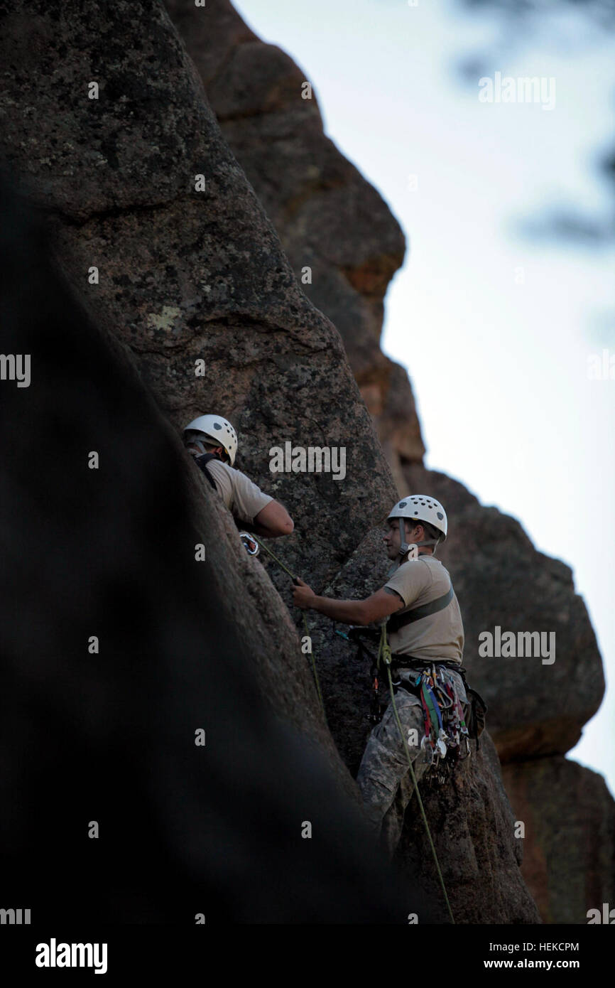 Soldiers attending the U.S. Army John F. Kennedy Special Warfare Center and School Mountaineering Program conduct Senior Course Level II training near Fort Carson, Colo., after completing the Basic Course (Level III) where team members learned 15 basic tasks, including navigating in mountainous terrain, rope commands, transportation of a casualty on an improvised litter and rappelling techniques. During Level II, the soldiers are expected to know and pass a hands-on test on the basic fundamentals of rock climbing throughout the course. Among the 17 tasks in the Senior Course they must be profi Stock Photo