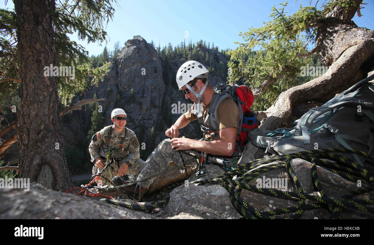 Soldiers attending the U.S. Army John F. Kennedy Special Warfare Center and School Mountaineering Program conduct Senior Course Level II training near Fort Carson, Colo., after completing the Basic Course (Level III) where team members learned 15 basic tasks, including navigating in mountainous terrain, rope commands, transportation of a casualty on an improvised litter and rappelling techniques. During Level II, the soldiers are expected to know and pass a hands-on test on the basic fundamentals of rock climbing throughout the course. Among the 17 tasks in the Senior Course they must be profi Stock Photo
