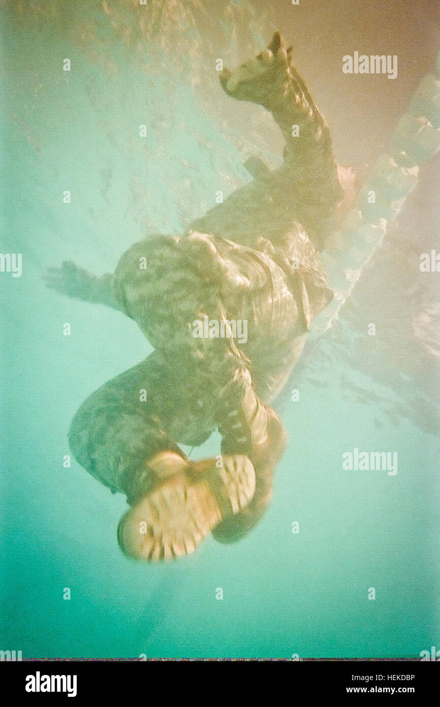A U.S. Soldier from Headquarters and Headquarters Company, U.S. Army Civil Affairs and Psychological Operations Command (Airborne), participates in water survival training, during battle assembly in Archer pool at Fort Bragg, N.C., Sept. 9, 2011. (U.S. Army photo by Staff Sgt. Felix Fimbres/Released) A U.S. Soldier from Headquarters and Headquarters Company, U.S. Army Civil Affairs and Psychological Operations Command (Airborne), participates in water survival training, during battle assembly in Archer pool 110909-A-CK868-818 Stock Photo