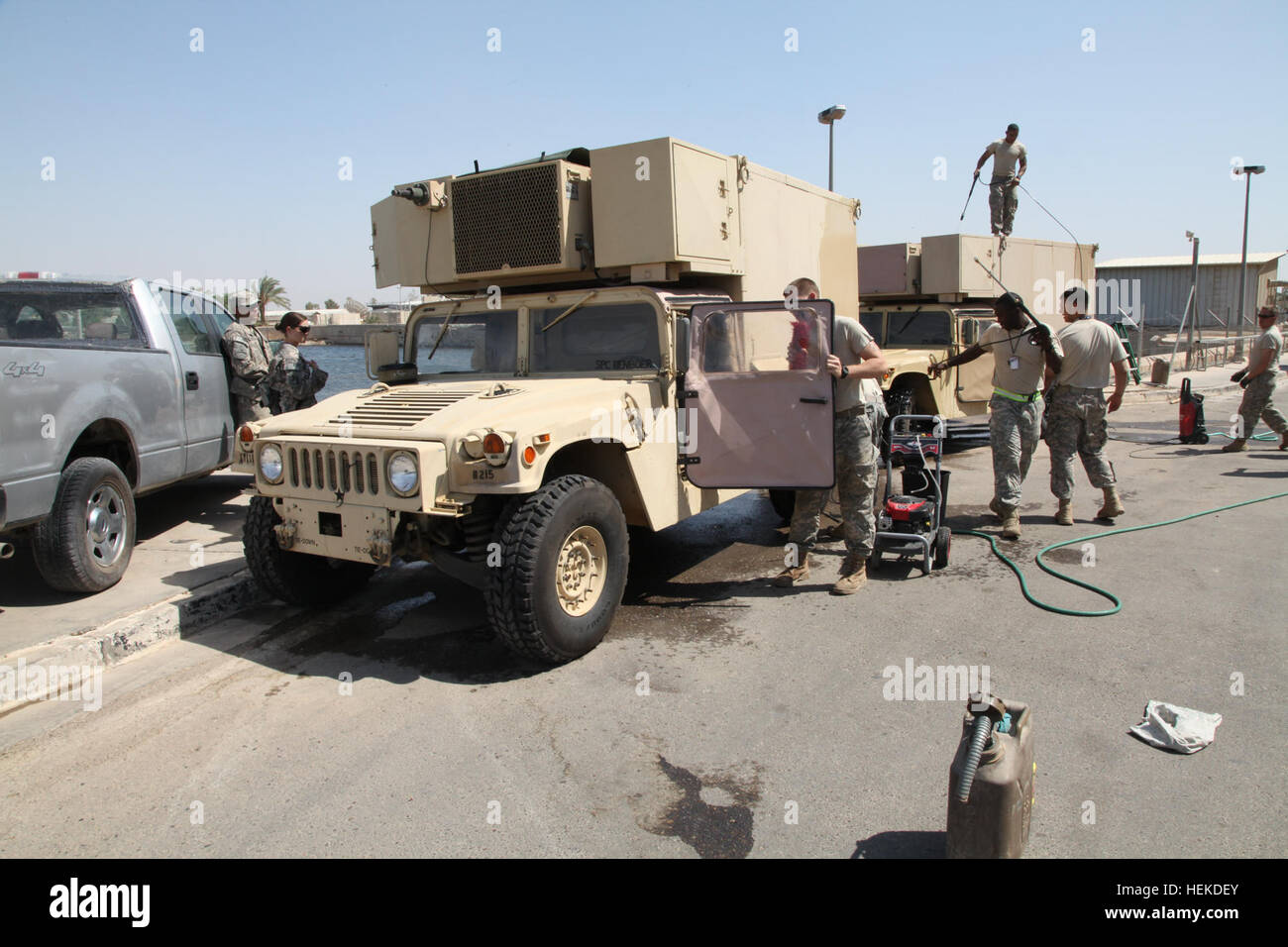 U.S. Army soldiers from the United States Forces - Iraq J2 shop clean their vehicles and equipment at Al-Faw Palace on victory Base Complex in Baghdad, Iraq, Sept. 11, 2011. The soldiers are preparing this equipment for its return to the United States as part of the draw down in support of Operation New Dawn. (U.S. Army photo by Sgt Matthew Friberg/Released) Troops clean vehicles on Victory Base Complex 110911-A-JL274-011 Stock Photo