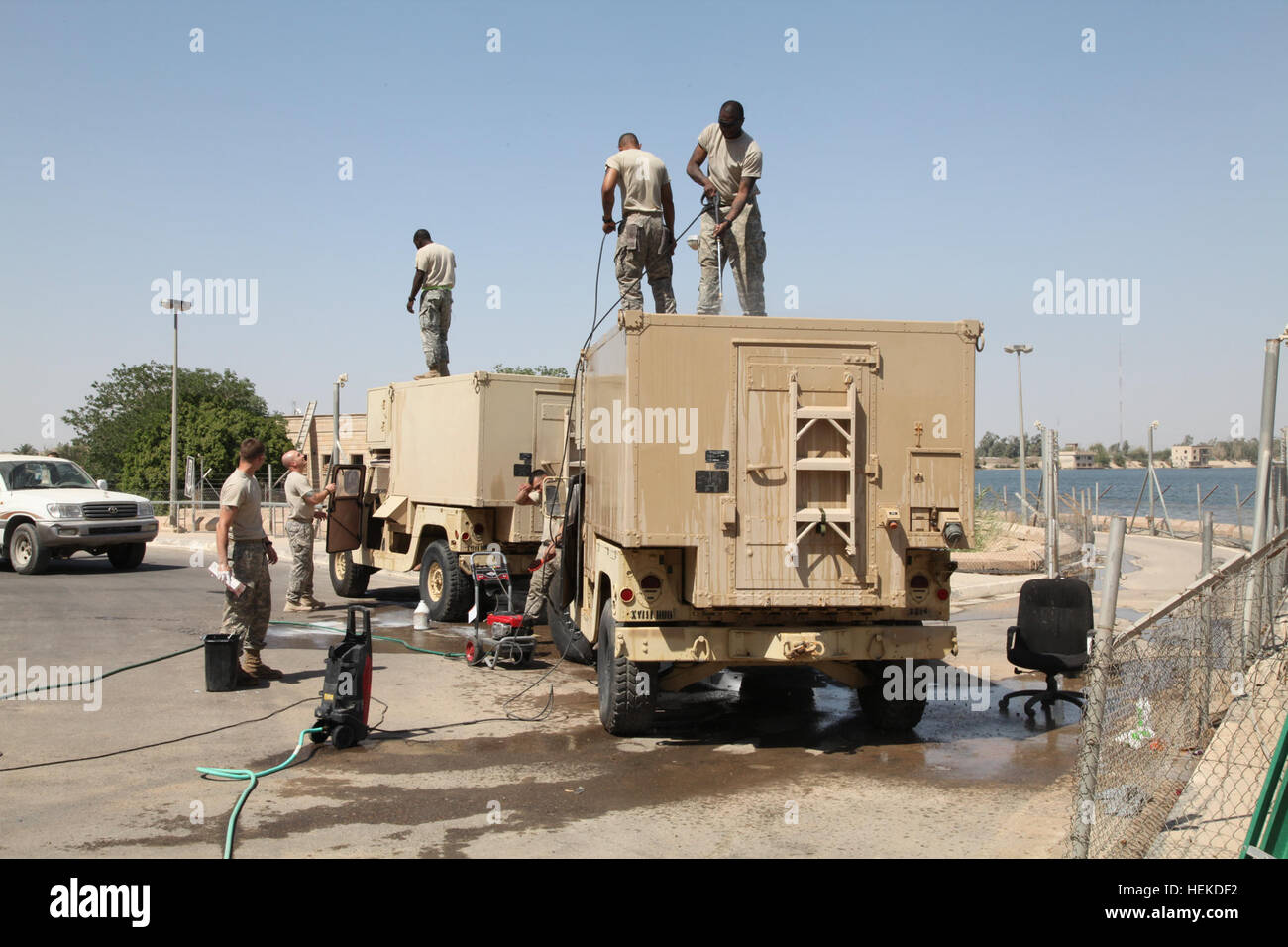 U.S. Army soldiers from the United States Forces - Iraq J2 shop clean their vehicles and equipment at Al-Faw Palace on victory Base Complex in Baghdad, Iraq, Sept. 11, 2011. The soldiers are preparing this equipment for its return to the United States as part of the draw down in support of Operation New Dawn. (U.S. Army photo by Sgt Matthew Friberg/Released) Troops clean vehicles on Victory Base Complex 110911-A-JL274-026 Stock Photo