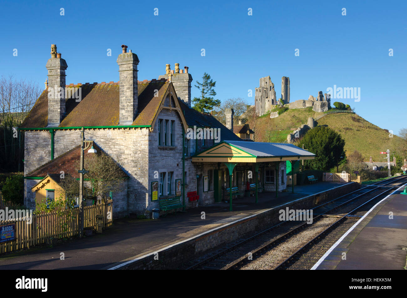 Corfe Castle, Dorset, UK. 22nd December 2016. UK Weather. Corfe Castle station in Dorset on the restored Swanage Railway basking under clear sunny blue skies. The footbridge across the tracks is a perfect vantage point to view the ruins of the castle which give the village its name. Picture: Graham Hunt/Alamy Live News Stock Photo