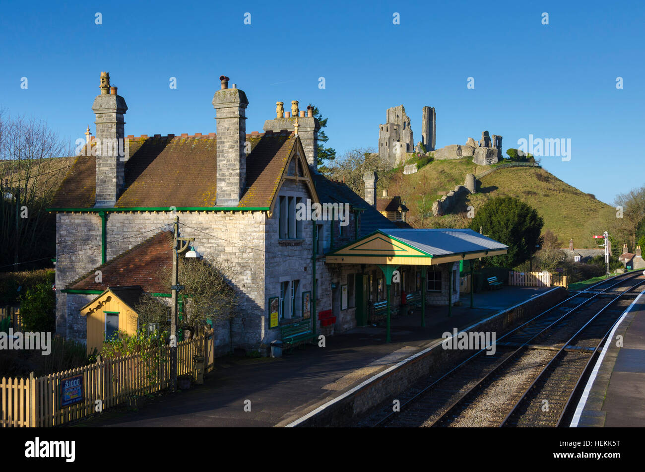 Corfe Castle, Dorset, UK. 22nd December 2016. UK Weather. Corfe Castle station in Dorset on the restored Swanage Railway basking under clear sunny blue skies. The footbridge across the tracks is a perfect vantage point to view the ruins of the castle which give the village its name. Picture: Graham Hunt/Alamy Live News Stock Photo