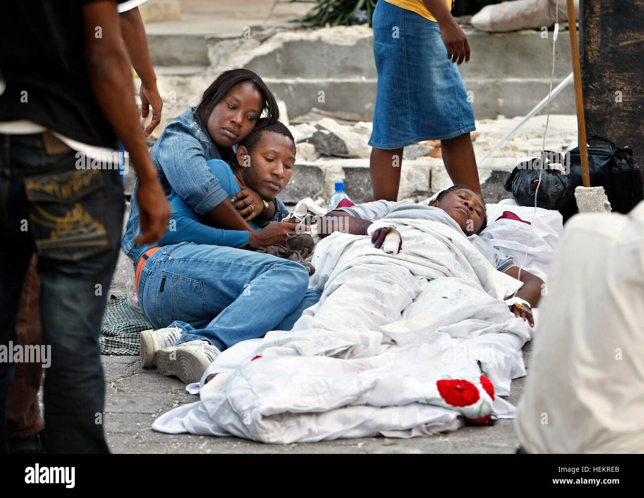 December 23, 2016 - Port-Au-Prince, Florida, U.S. - 011810 (Lannis Waters/The Palm Beach Post) PORT-AU-PRINCE, HAITI - Loved ones sit with a patient in a courtyard outside Sacre Cour Hospital in Port-au-Prince. Many patients wait there for treatment, are treated outside, and recover on the ground outdoors. (Credit Image: © Lannis Waters/The Palm Beach Post via ZUMA Wire) Stock Photo