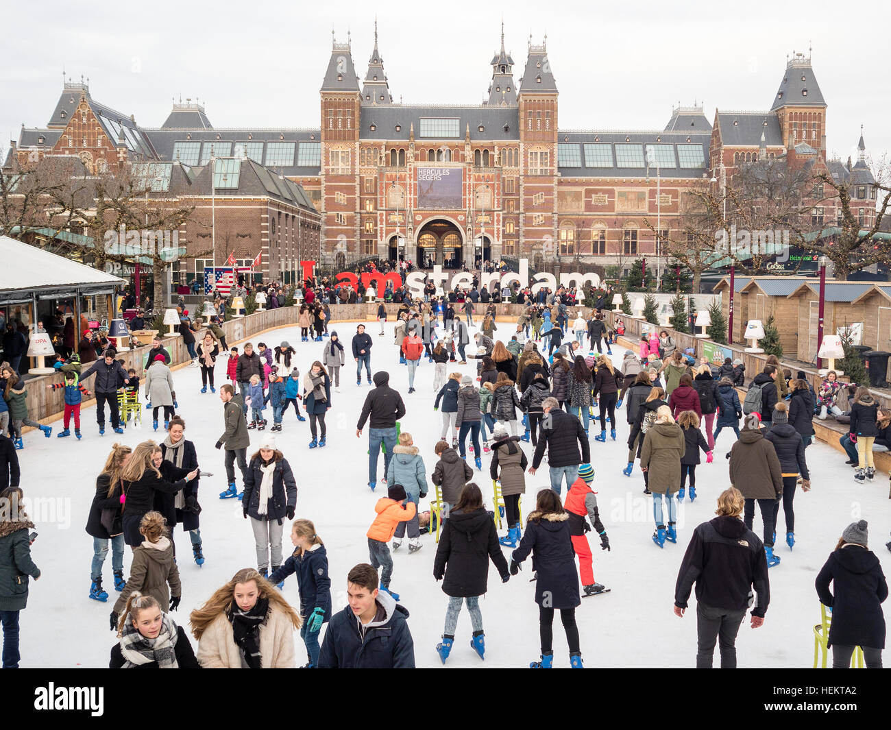 Amsterdam, The Netherlands. 23rd, 2016. During these days a lot of tourists that have arrived to the capital of the Netherlands, Amsterdam, are enjoying the so many attractions that you can enjoy around the whole city. One of the most important is the ice skating at the Museumplein where you can also enjoy of a Christmas market and take a hot drink during this cold days. Credit: Romy Arroyo Fernandez/Alamy Live News. Stock Photo