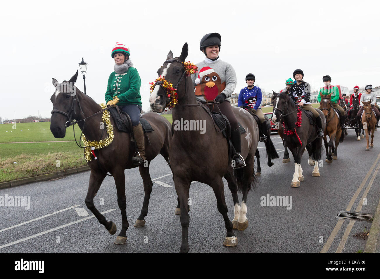 London, UK. 24th Dec 2016. Soldiers from the King's Troop Royal Horse Artillery and their horses wear Christmas outfits, tinsel and santa hats as they ride out on Christmas Eve morning. The soldiers left Woolwich Barracks and trotted through south east London streets to Morden College in Blackheath, where the soldiers were greeted with mulled wine and minced pies. The annual event has become a new Christmas tradition since the KingÕs Troop moved to purpose built barracks in Woolwich in February 2012. Credit: Vickie Flores/Alamy Live News Stock Photo