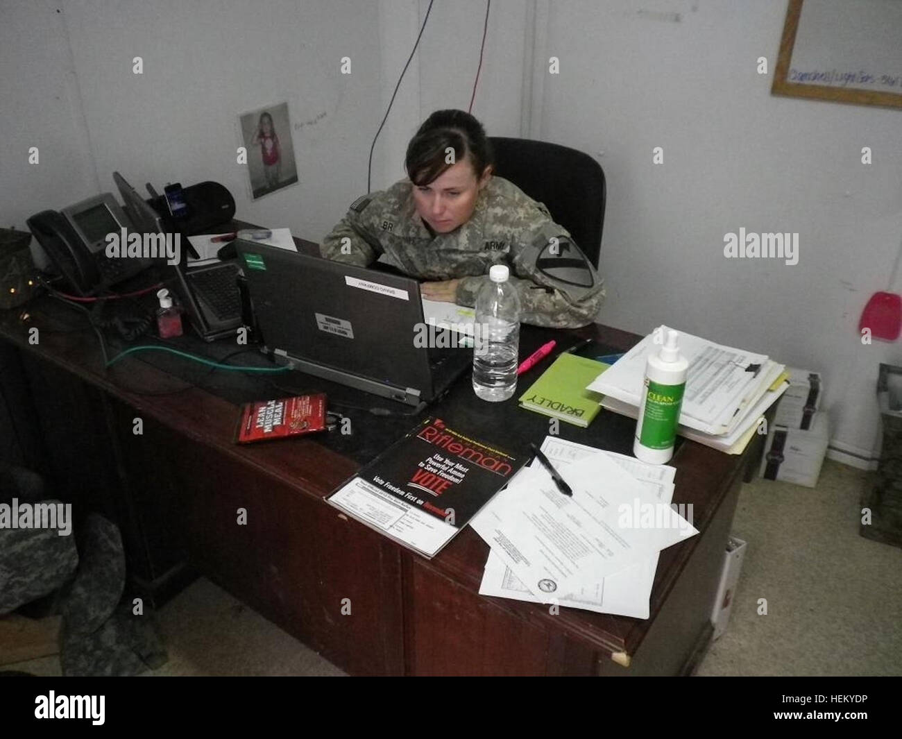 First Lt. Tiffany Bradley, B FMC, 215th Brigade Support Battalion, 3rd Advise and Assist Brigade, 1st Cavalry Division, a native of Columbus, Ga., works at her computer in an effort to get equipment turned in Oct. 24, 2011, at Contingency Operating Base Adder, Iraq. (Photo by: 2nd Lt. Samuel Eldridge, B FMC, 215th BSB, 3rd AAB, 1st Cavalry Division) Maintenance company prepares for redeployment 484855 Stock Photo