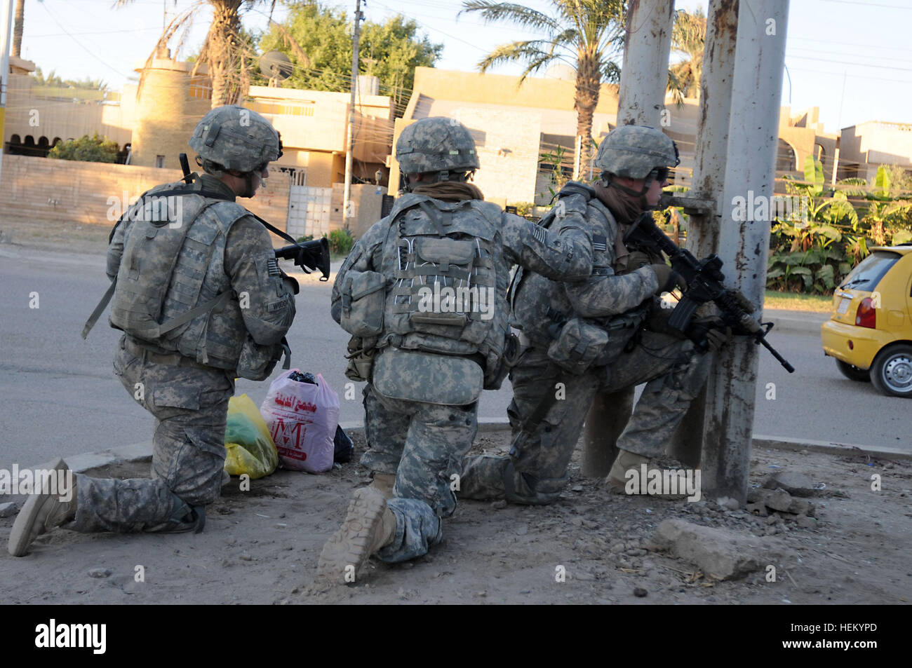 In the early morning light, paratroopers from B Company, 2nd Battalion, 325th Airborne Infantry Regiment take a knee at a street corner before continuing a patrol in the city of Baghdad, Oct. 23. With a long history of supporting U.S. military operations in Iraq, the 2-325th AIR of the 2nd Brigade, 82nd Airborne Division is enabling the withdrawal of U.S. military forces in Iraq. Walking the streets of Baghdad 478623 Stock Photo