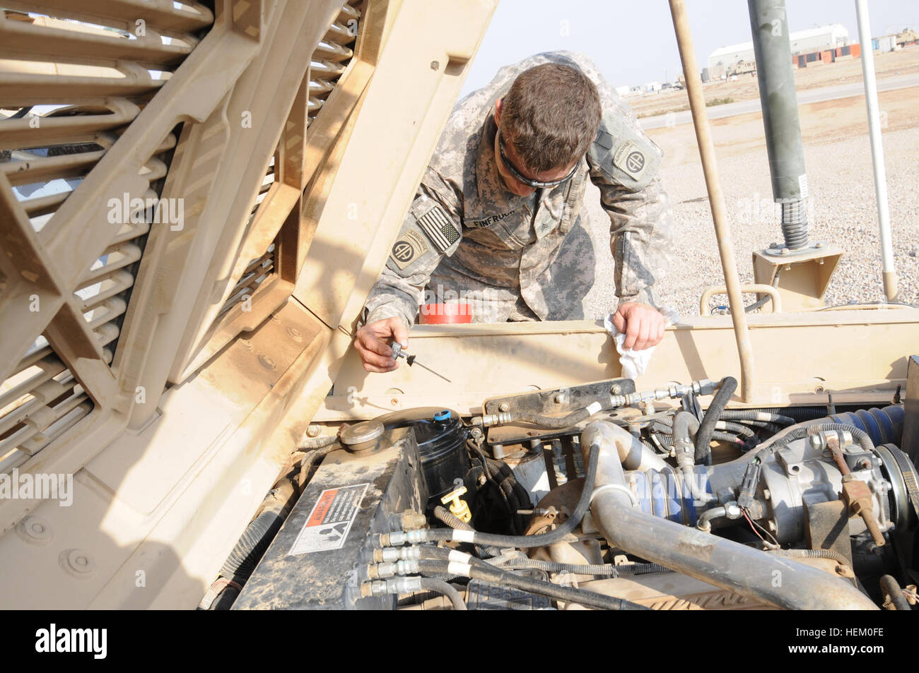 A paratrooper with 2nd Battalion, 319th Airborne Field Artillery Regiment, 2nd Brigade, 82nd Airborne Division checks the oil in his Mine Resistant Ambush Protected vehicle at Contingency Operating Base Adder, Iraq, Nov. 16. American paratroopers bid farewell to Ramadi 491209 Stock Photo