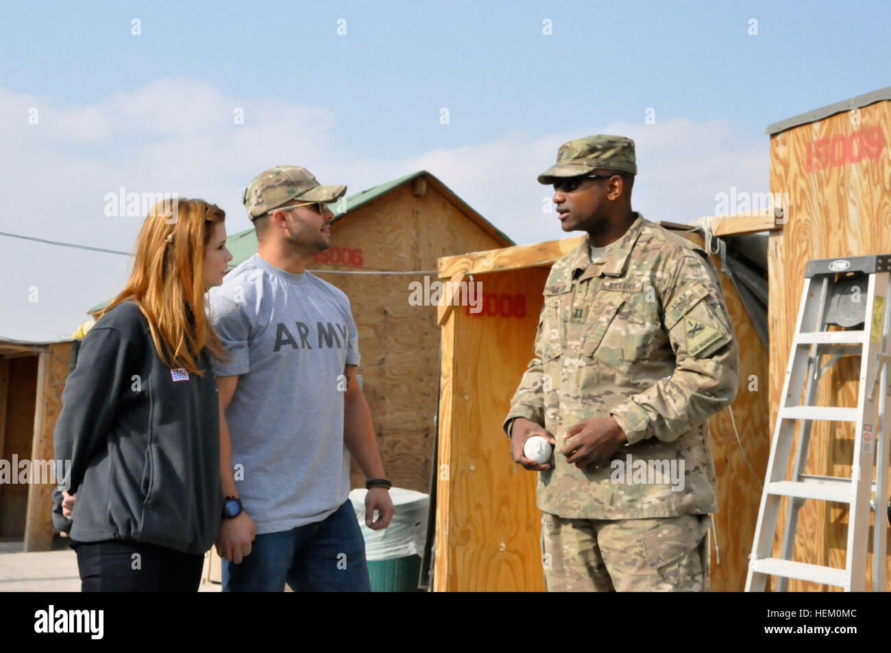 LOGAR PROVINCE, Afghanistan – Actress JoAnna Garcia Swisher and New York Yankees fielder Nick Swisher listen as Capt. Michael A. Miller, a native of Buffalo, New York and commander of C Medical Company, 125th Brigade Support Battalion, describes his company’s medical facilities at Forward Operating Base Shank, Afghanistan, Friday, Nov. 25. The celebrity couple greeted troops and signed autographs as part of a USO tour. (U.S. Army photo by Maj. Terence M. Kelley) Nick and JoAnna Swisher visit FOB Shank 492101 Stock Photo