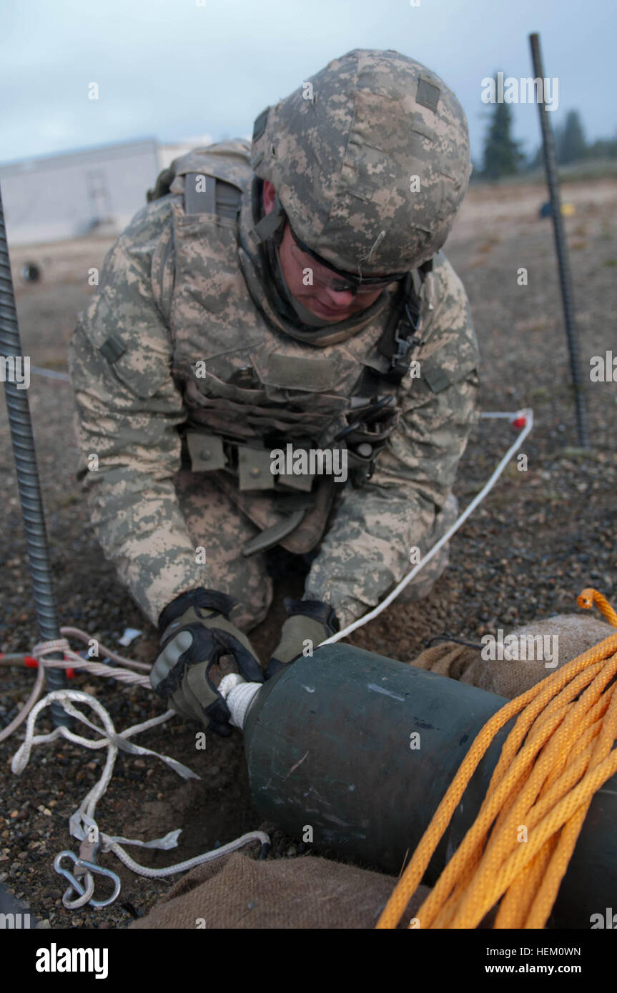 Sgt. Daniel Cummings, assigned to the 725th Ordnance Battalion at Fort Drum, N.Y., performs explosive ordnance disposal tape-and-line procedures during the EOD Team Leader Training Academy at Joint Base Lewis-McChord, Wash., Dec. 6. The 3rd Ordnance Battalion hosted the 20th Support Command Team Leader Training Academy in order to provide prospective EOD team leaders and team members with realistic scenario-based leader training in a controlled environment. Soldiers train to become EOD leaders 496353 Stock Photo