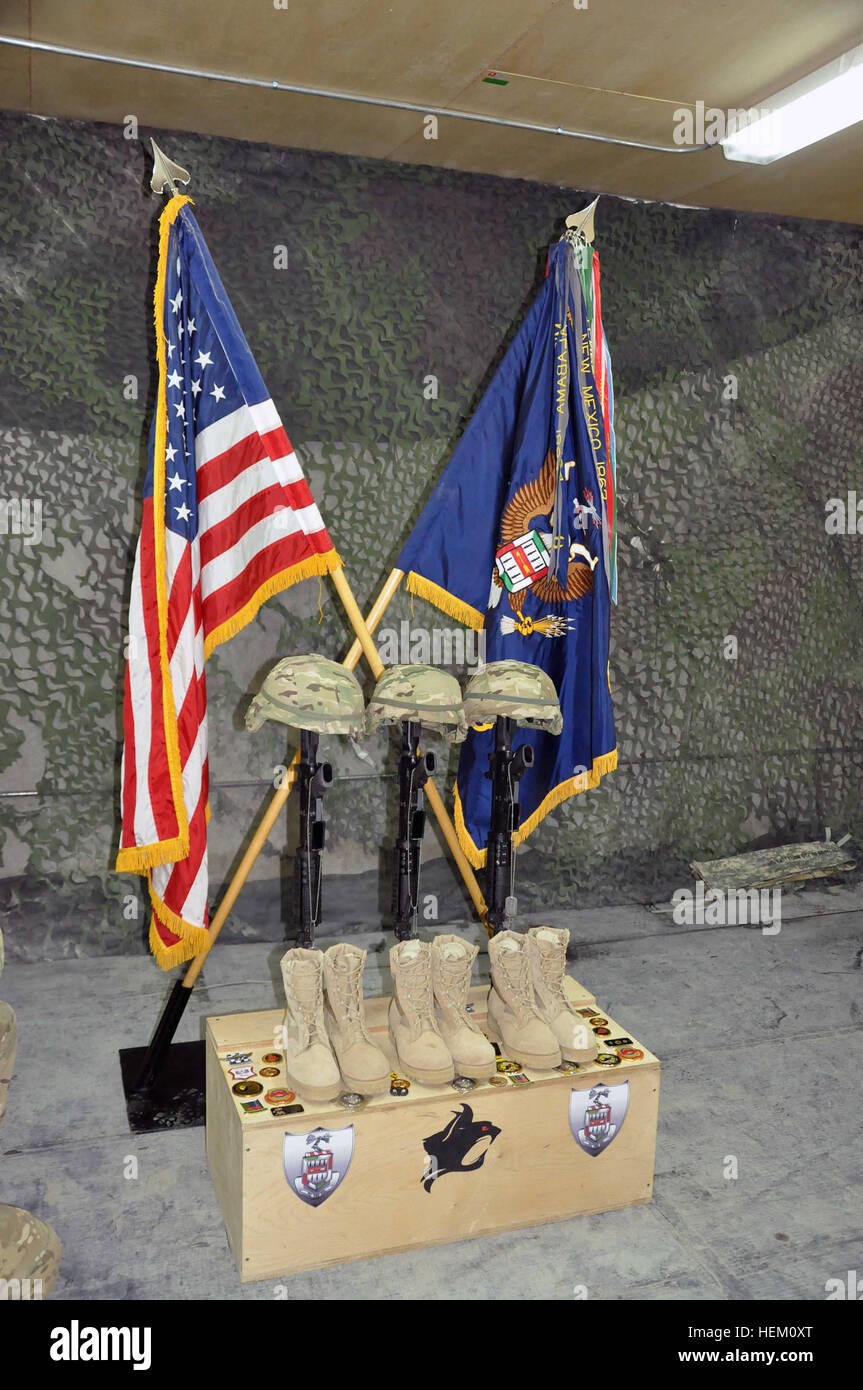WARDAK PROVINCE, Afghanistan –Unit coins lay on the memorial stand for Sgt. 1st Class Clark Corley, Spc. Ryan Lumley, and Spc. Thomas Mayberry following a memorial service at Combat Outpost Sultan Khel, Wednesday, Dec. 7.  The three men, members of Action Company, 2nd  Battalion, 5th Infantry, were killed in action Dec. 3, 2011 after their vehicle struck an IED. Senior officers traditionally leave the coins on behalf of their units to honor the fallen Soldiers. Action Company, part of the 3rd Brigade Combat Team, 1st Armored Division, is based out of Fort Bliss, Texas and is the first unit fro Stock Photo