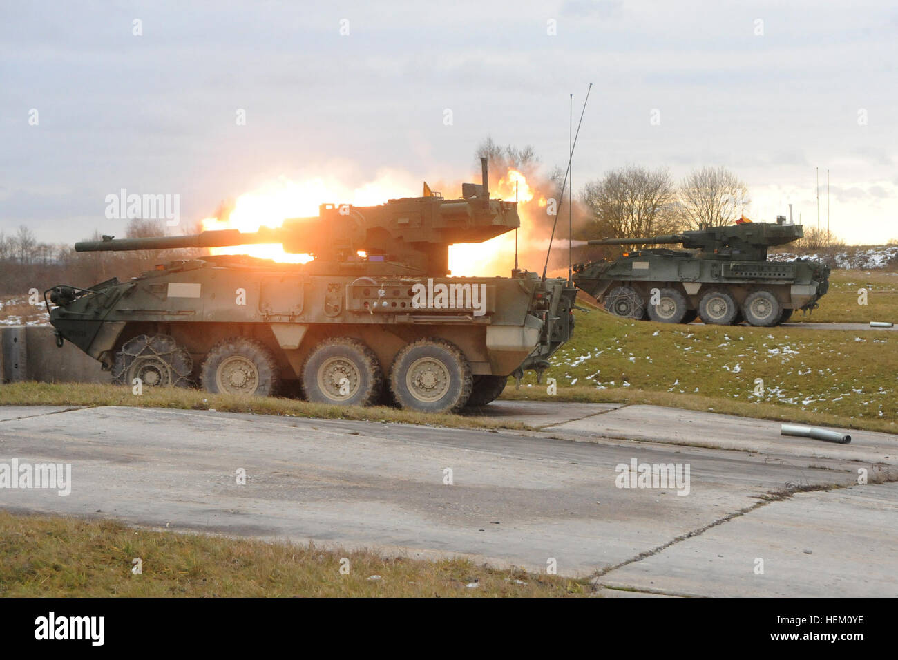 A U.S. Army Stryker Mobile Gun System vehicle fires its 105 mm main gun during Operation Iron Panzer. Iron Panzer is a combined live-fire exercise between the U.S. Army’s 3rd Squadron, 2nd Cavalry Regiment, and the German Bundeswehr’s 4th Company, 104th Panzer Battalion. This is the first combined live-fire exercise that will incorporate both the German Leopard 2 tank and the American Stryker Mobile Gun System. 'Iron Panzer' combined live-fire exercise 111208-A-HE359-006 Stock Photo