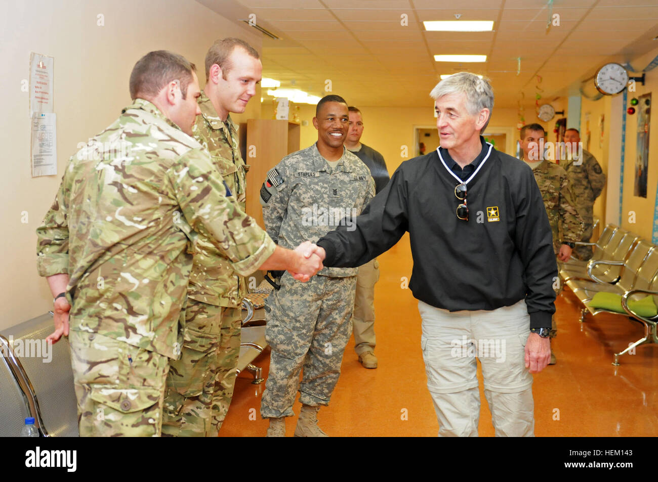 Hon. John McHugh, secretary of the Army, being escorted by Navy Master Chief Petty Officer Keith Staples, Task Force Medical- South and NATO Role 3 Multinational Hospital master chief, greets British hospital workers during a visit to Kandahar Airfield Dec. 14. The objective of McHugh's visit was to assess the current status of U.S.-Afghan relations in RC(S) and to see military training and facilities. Secretary of the Army meets hospital workers at Kandahar Airfield's Role 3 499697 Stock Photo