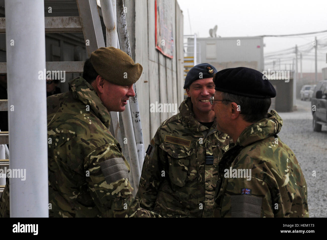 British Gen. Sir David J. Richards, chief of the Defense Staff, is greeted by Maj. Justin Hughes, Regional Command (South) CJ-3/5, and Wing Commander Rob Humphries, ISAF Joint Command headquarters, as he arrives at RC(S) headquarters on Kandahar Airfield Dec. 20. Richards accompanied Prime Minister David Cameron for his surprise visit to see British troops in the area and to meet briefly with RC(S) leadership. British Chief of Defense Staff greets British service members in Regional Command (South) 503049 Stock Photo