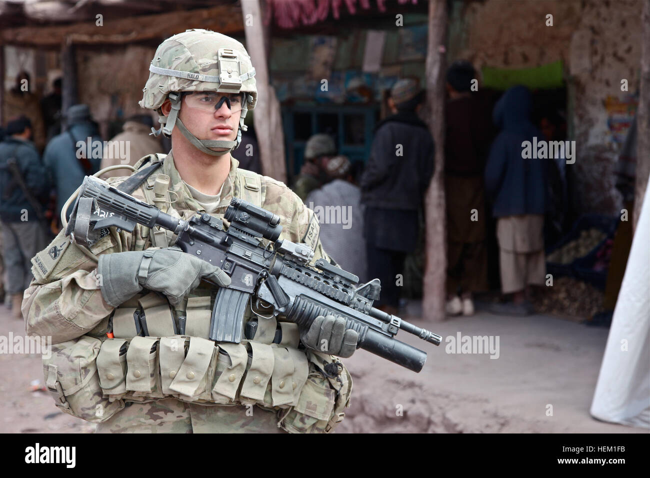 U.S. Army Pvt. John Halo, from Germantown, Md., serving with 2nd Platoon, A Company, 141st Infantry Regiment, 3rd Infantry Brigade Combat Team, 1st Armored Division, Fort Bliss, Texas, provides security in the Azrah district bazaar, Logar province, Afghanistan, Jan. 2, 2012. The objective of the mission was for U.S. forces to build relationships with the Afghan Uniformed Police and local populous. Operation Mongoose 120102-A-BZ540-130 Stock Photo