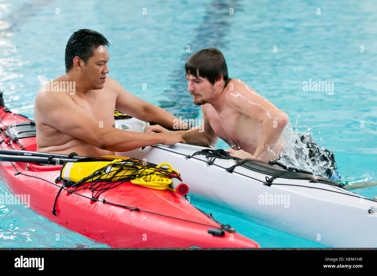 James Arriola, left, a new kayaker, assists Bradley Hinton, kayak class