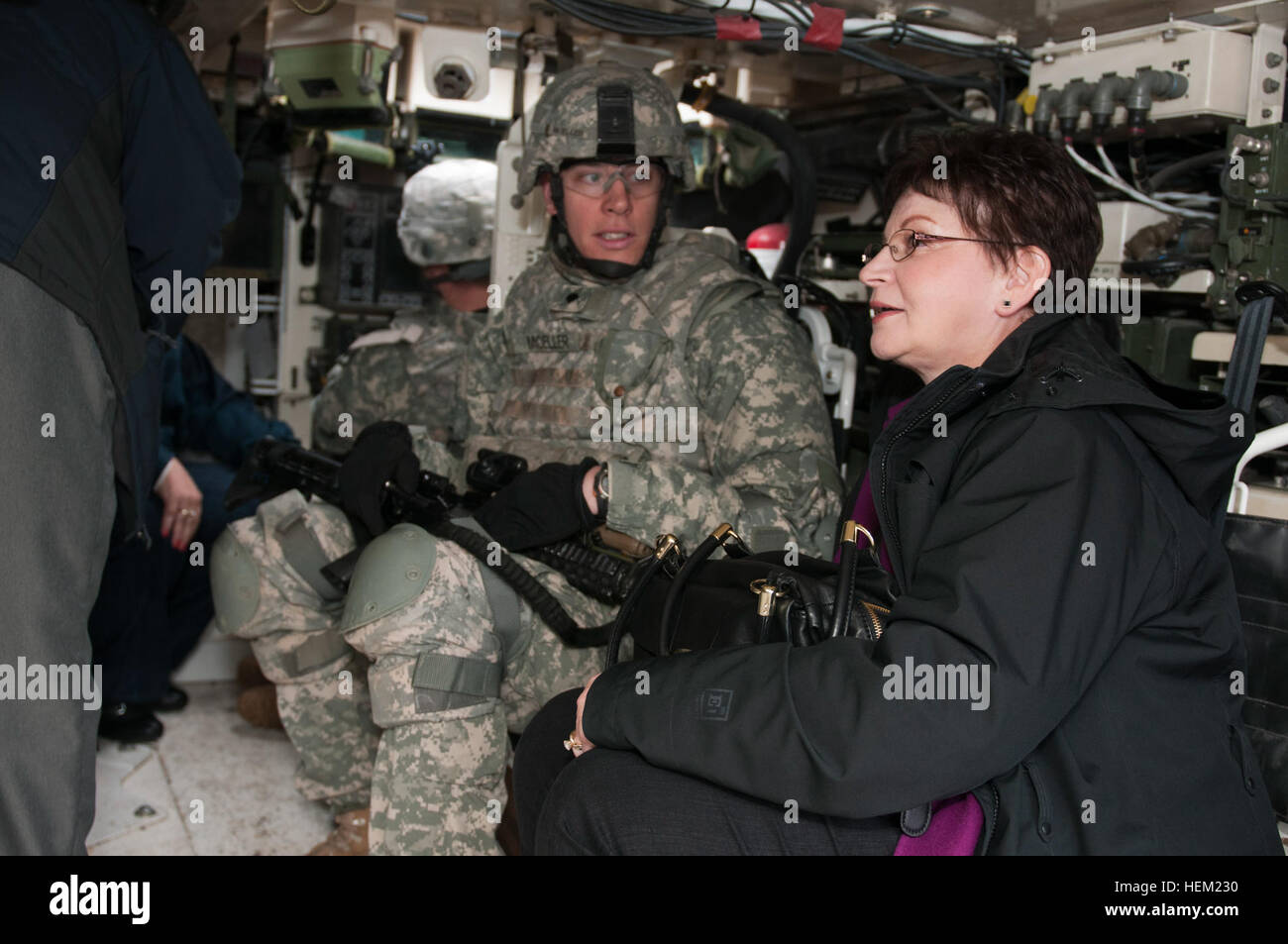 (Left) Spc. Kurt Moeller, who serves as a combat medic with the 1-17th Infantry Battalion, 2nd Stryker Brigade Combat Team, 2nd Infantry Division, discusses with Melanie Warren, the capabilities of the Army’s newest combat vehicle, the M1130 Command Stryker Vehicle during a community connector event held at Joint Base Lewis-McChord, Wash., Jan. 23. The event acted as an opportunity for members of the chamber of commerce for Puyallup and Sumner, Wash., to get an understanding of how they can better support the service members of JBLM. Lancers welcome two cities 514758 Stock Photo