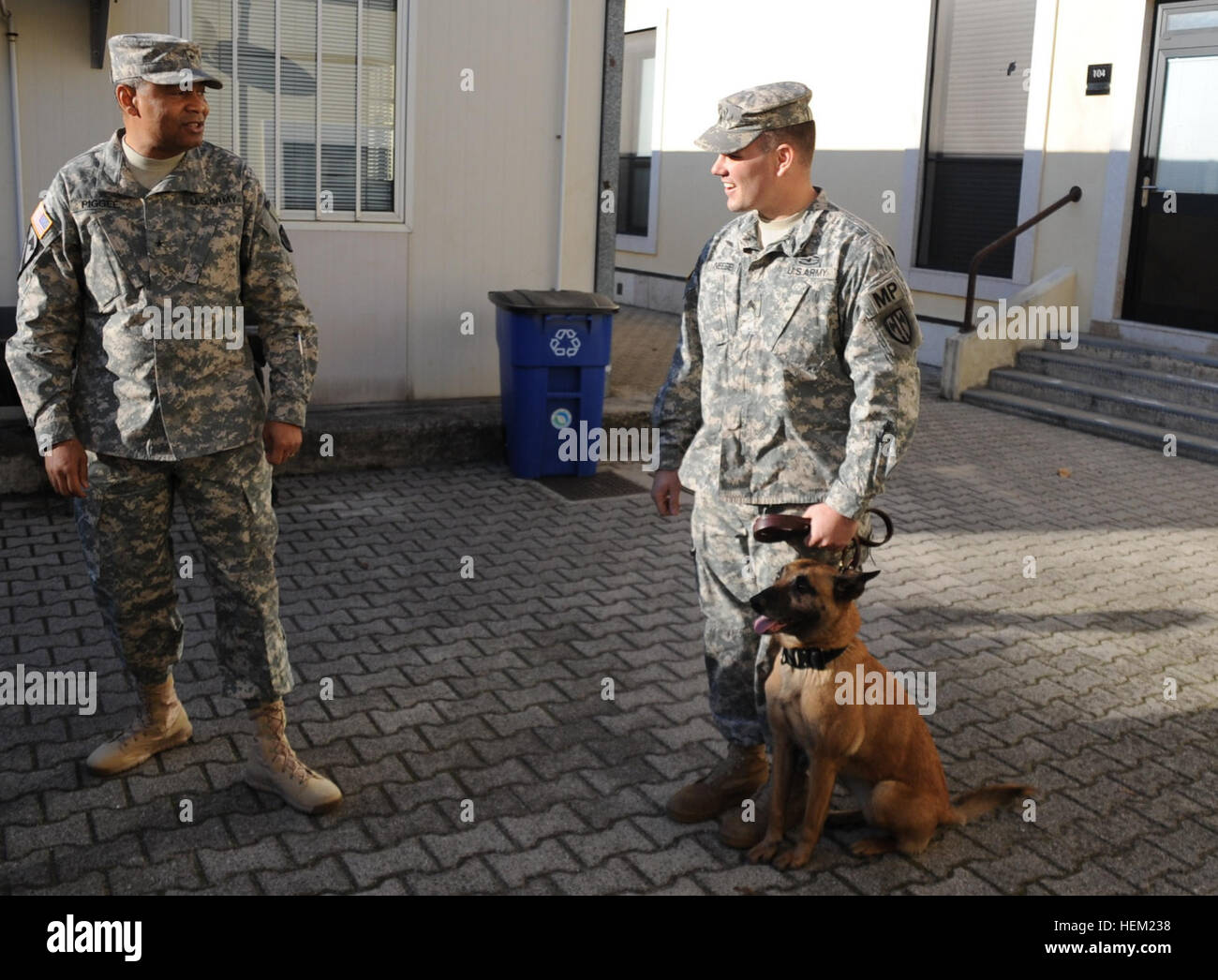 Sgt. Robert Neese, a military working dog handler with the 464th Military Police Platoon in Vicenza, Italy, explains some of the duties he and dog Rita perform to the 21st Theater Sustainment Command’s commanding general, Brig. Gen. Aundre Piggee, during the general’s recent visit to units of the 21st TSC in Italy Jan. 24. 21st TSC-Italy units sustain a variety of services 516938 Stock Photo