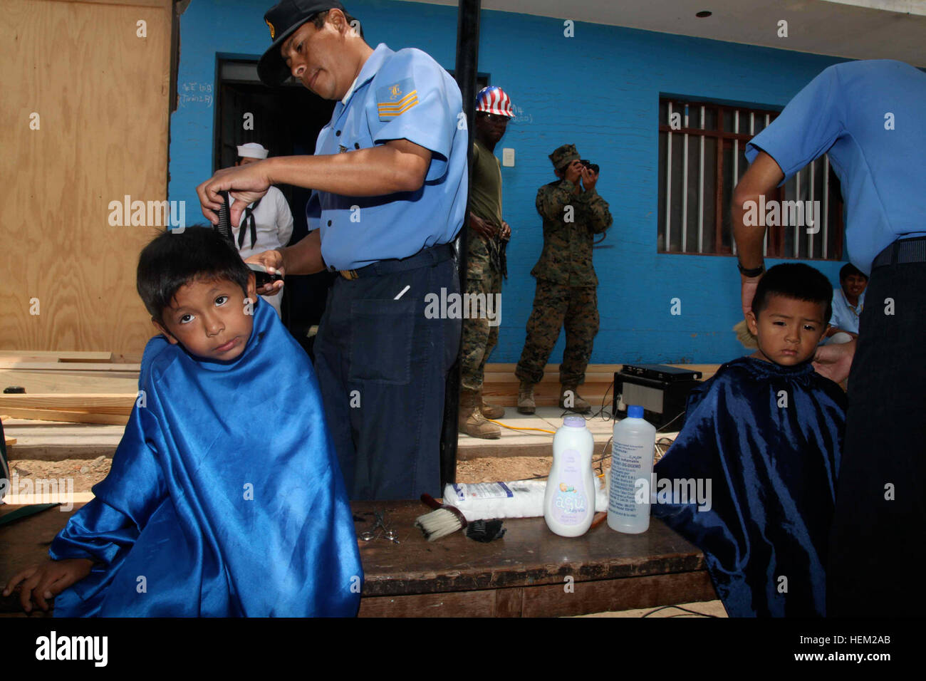 120203-A-IP644-028 CALLAO, Peru (February 3, 2012) A boy gets his hair cut by a Peruvian Sailor before a ceremony honoring the finished construction of an elementary school in Zona De Acapulco. Navy Seabees assigned to Naval Mobile Construction Battalion (NMCB 23), embarked on High Speed Vessel (HSV-2) Swift, were refurbishing the school with Peruvian combat engineers from Base Naval De Callao and Brigada Infanteria De Marina De Ancon as a part of HSV-Southern Partnership Station 2012 (HSV-SPS 12). HSV-SPS is an annual deployment of U.S. Navy ships and assets to the U.S. Southern Command???s a Stock Photo