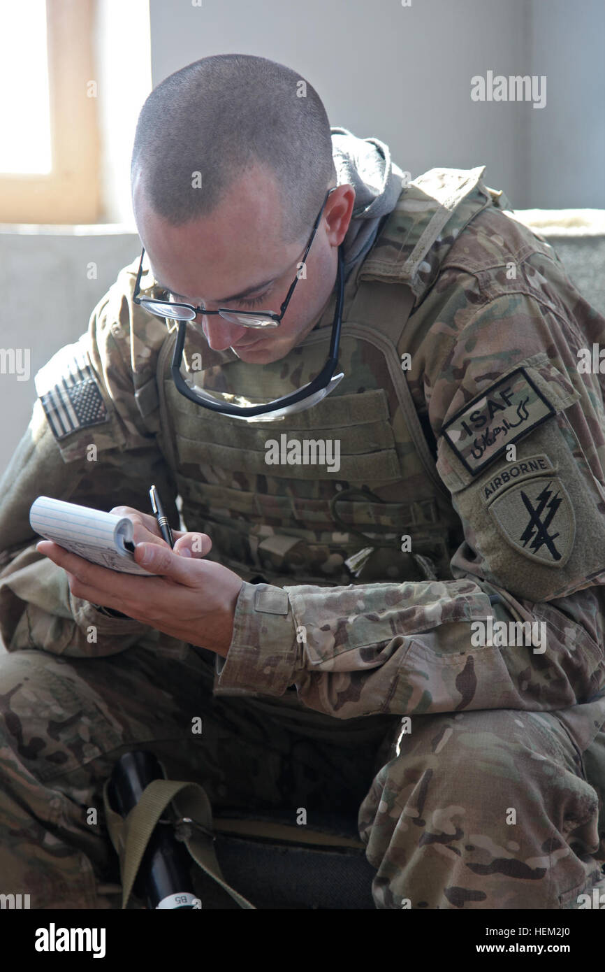 U.S. Army 1st Lt. Daniel McElroy, from Boston, assigned to Civil Affairs Team 19, 443rd Civil Affairs Battalion, New Port, R.I., takes notes during a key leader engagement with the sub-governor and other local Afghans about the details of Farmers Day, in the Sayed Abad district center, Wardak province, Afghanistan, Feb. 13, 2012. Farmers Day meeting 120213-A-BZ540-020 Stock Photo