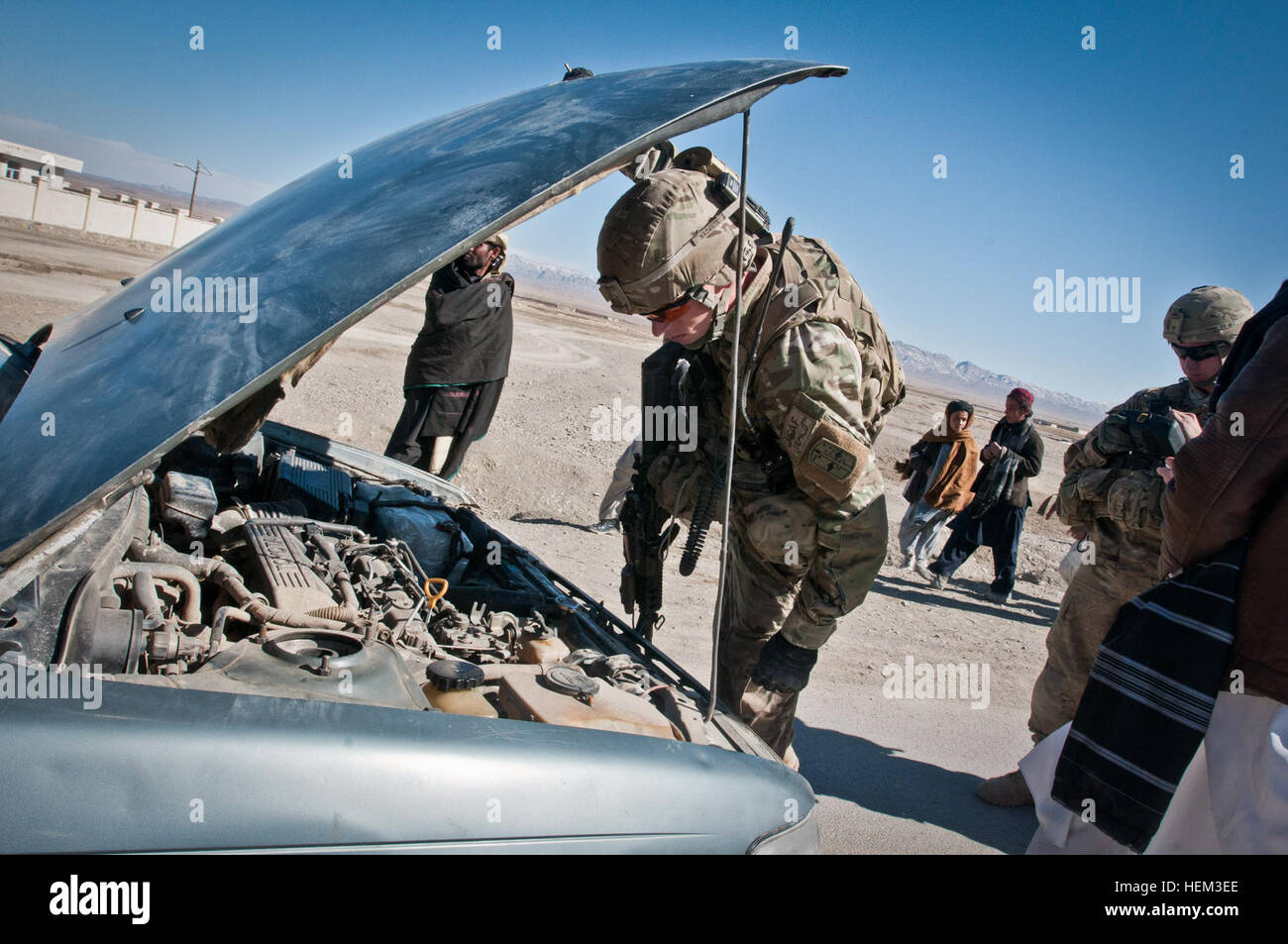 PAKTIKA PROVINCE, Afghanistan -- U.S. Army Sgt. Cody Dehart, a native of Greensburrough, N.C., and a member of 1st Platoon, Company A, 1st Battalion, 2nd Infantry Brigade, Task Force Blackhawk, checks a vehicle for explosives during a traffic check point set up by 1st Plt. and the Afghan Uniformed Police near the small village of Yahya Khel March 10. (U.S. Army photo by Sgt. Ken Scar, 7th MPAD) TF Blackhawk soldiers turn the tide from tiny COP Yosef Khel 120309-A-ZU930-019 Stock Photo