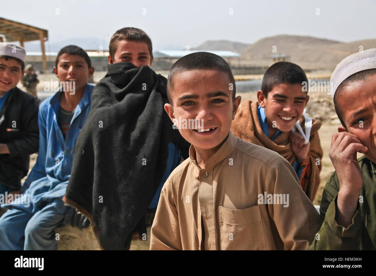 Local Afghan boys smile at U.S. soldiers in Nazyan district, Nangarhar province, Afghanistan, March 15, 2012. The purpose of the mission was to gain familiarization of the district and key leadership. Key leader engagement 120315-A-LP603-130 Stock Photo