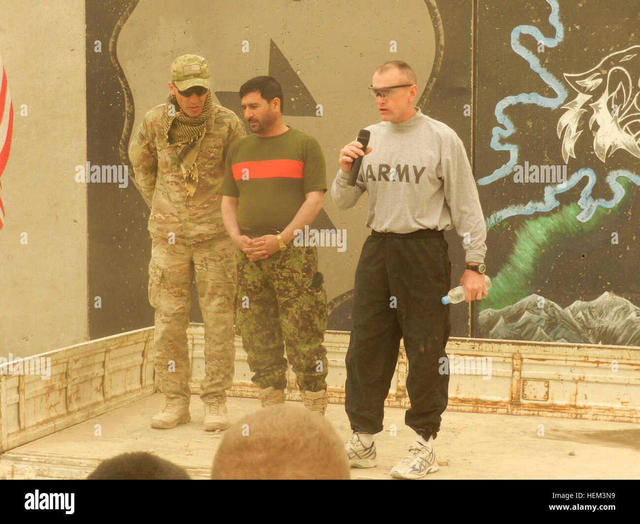 Col. Todd Wood, commander of Task Force Arctic Wolves, and Afghan Brig. Gen. Amad Habibi, commander of the 1st Brigade, 205th Afghan National Army Corps, address the crowd of soldiers preparing for a St. Patty's Day 5k run at Forward Operating Base Masum Ghar in Panjwa'i district of southern Kandahar province, Afghanistan, March 19, 2012. Partnership Patty's Day Run 120319-A-AX328-002 Stock Photo