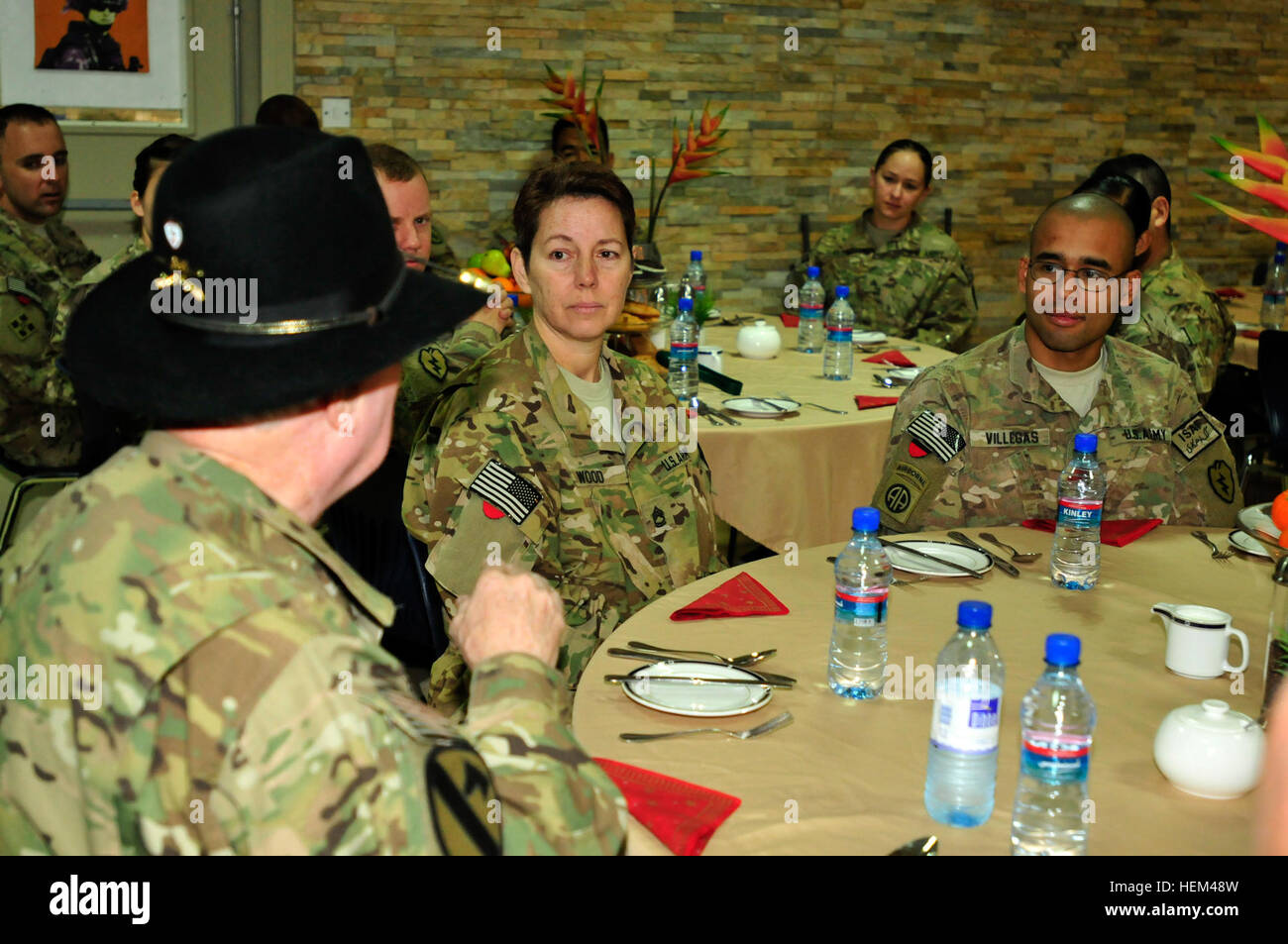 Retired Col. Bruce Crandall, Medal of Honor recipient, talks to soldiers of Headquarters and Headquarters Company, 25th Combat Aviation Brigade, before eating breakfast at a dining facility during his visit to Kandahar Airfield, Afghanistan, March 30. Crandall was awarded the medal of honor for his heroic actions in the Battle of Ia Drang in 1965 and continues to show his support for today's soldiers. Retired Col. Bruce Crandall, Medal of Honor recipient, visits 25th CAB 120330-A-UG106-011 Stock Photo